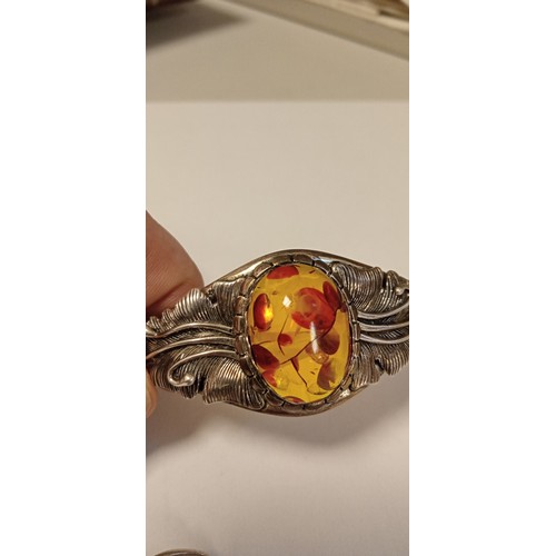 79 - 925 stamped decorative bangle with possible amber inlaid stone plus white metal ring