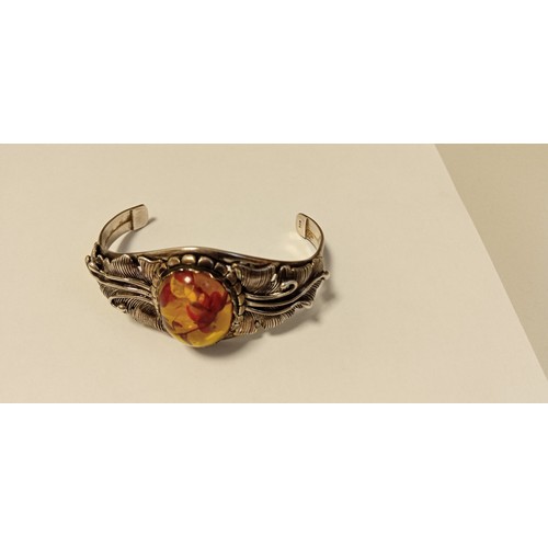 79 - 925 stamped decorative bangle with possible amber inlaid stone plus white metal ring