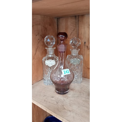 242 - 2 Crystal decanters plus one other