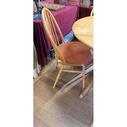 333 - Ercol round dining table with 4 chairs in light wood with gold button