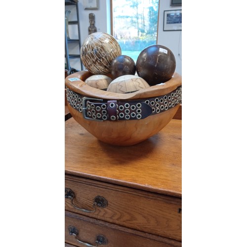 337 - Wooden bowl with belt and selection of decorative balls