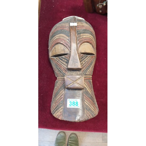 388 - African face mask and standing African figurines