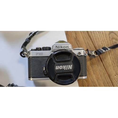 2 - Nikon FE2 35mm camera with Nikkor 28mm lens plus Praktica B100 electronic camera