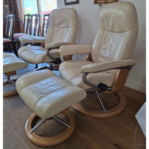 7 - Pair of Ekornes stressless cream leather reclining chairs and footstools