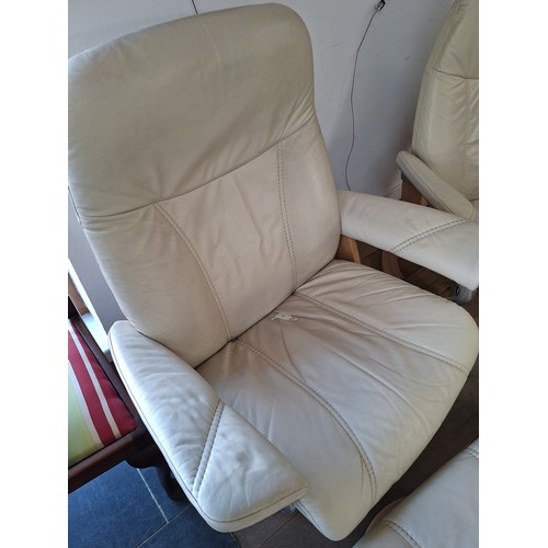 7 - Pair of Ekornes stressless cream leather reclining chairs and footstools
