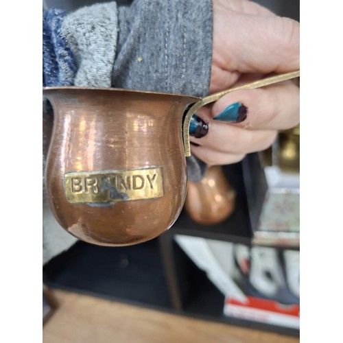 190 - Brass large candle holder, brass boots and copper spirit ladles