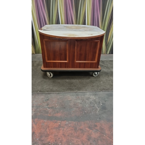 208 - 7  x mobile room service carts finished in custom wood veneer storage compartment features room for ... 