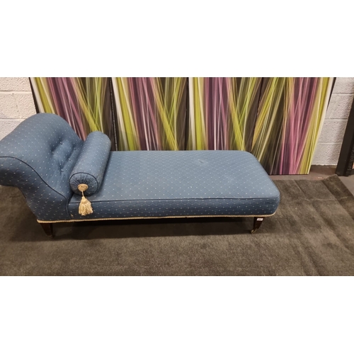 200 - Chaise lounge upholsteres in blue with god repeating pattern on castor wheel complete with bolster 1... 