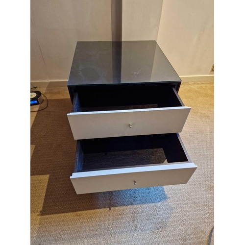 61 - A pair of bedside cabinets by Benhardt black ash mounted glass protective top on stainless steel bas... 