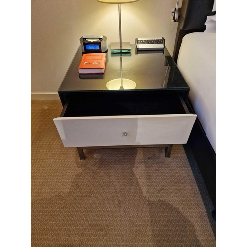 64 - A pair of bedside cabinets by Benhardt black ash mounted glass protective top on stainless steel bas... 