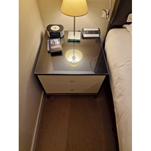 68 - A pair of bedside cabinets by Benhardt black ash mounted glass protective top on stainless steel bas... 