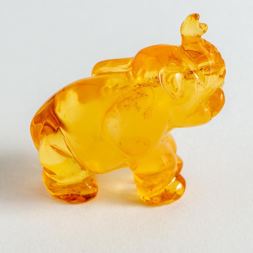 29 - Hand Carved semi-Transparent Natural Baltic Amber Elephant Figurine. Orange to Yellow colours, milky... 