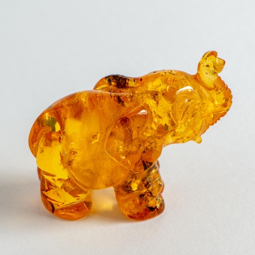 61 - Hand Carved Transparent Natural Baltic Amber Elephant Figurine. Light Orange colour Amber with visib... 