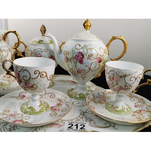 212 - Antique gilt and hand painted very pretty tea set complete possibly Limoges (one cup has hairline cr... 