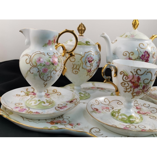 212 - Antique gilt and hand painted very pretty tea set complete possibly Limoges (one cup has hairline cr... 