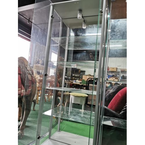 428 - Glass two door display cabinet with built in light and four glass shelves, mirrored back, height 168... 