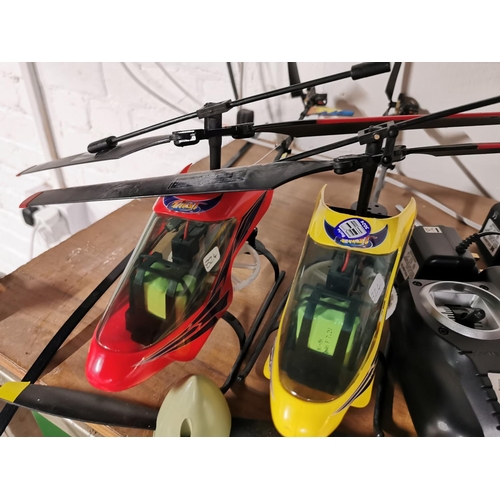 112 - Two stunt radio controlled helicopters with two controllers two chargers etc