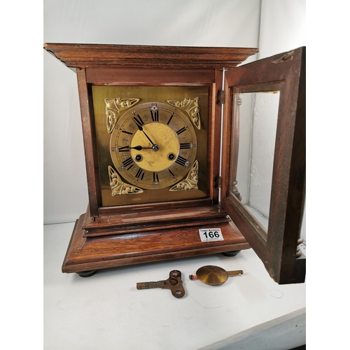 166 - Vintage oak mantle clock with brass dial with key and pendulum, 33cm high, 31cm wide, 18cm deep