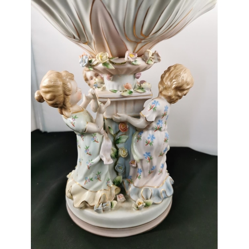 202 - An ornate ceramic figural bowl with three children holding a pillar in good condition with a cross s... 