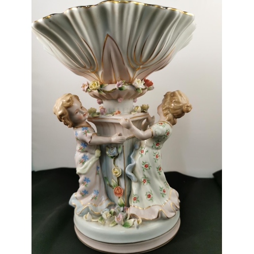 202 - An ornate ceramic figural bowl with three children holding a pillar in good condition with a cross s... 