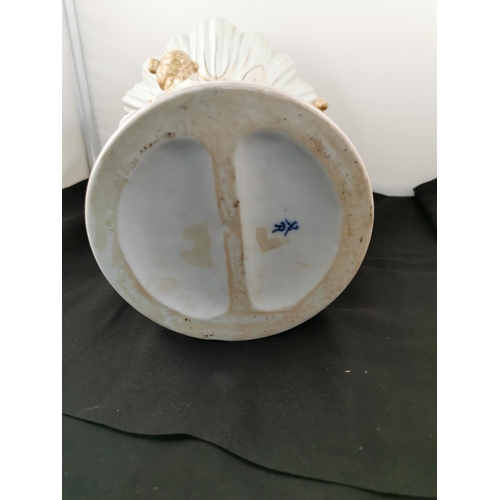 202 - An ornate ceramic figural bowl with three children holding a pillar in good condition with a cross s... 