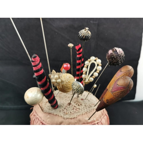 227 - Large Victorian pin cushion containing a large quantity of various types of hat pins