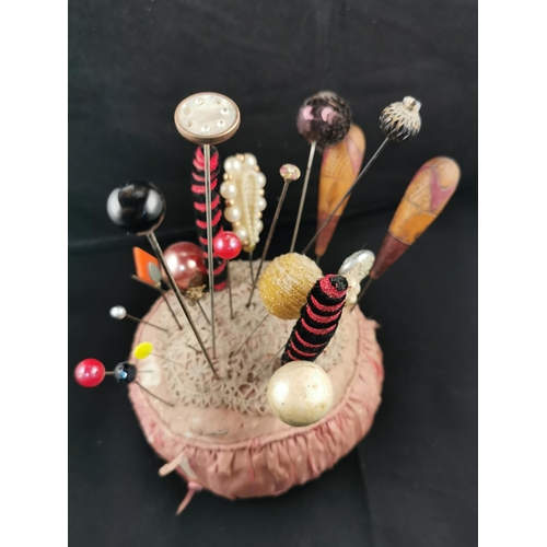 227 - Large Victorian pin cushion containing a large quantity of various types of hat pins