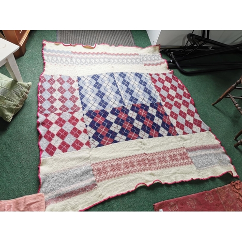 29 - Two pink woollen blankets a Victorian red table cloth and a handmade woollen blanket which has a few... 