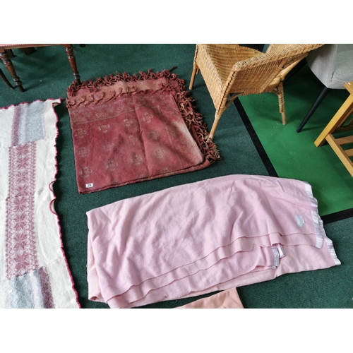 29 - Two pink woollen blankets a Victorian red table cloth and a handmade woollen blanket which has a few... 