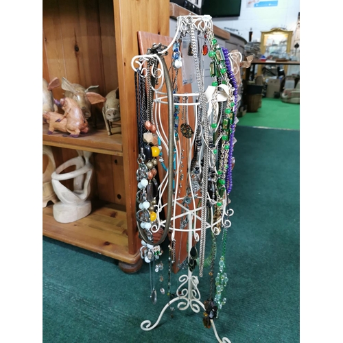 85 - Tall metal jewellery stand draped with costume jewellery 72cm high