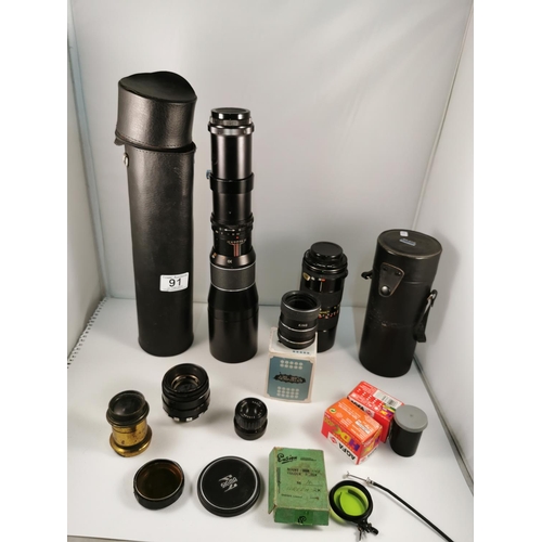 91 - Quantity of camera lenses and camera films inc, a Tamron 85-210mm lens, a Japanese long zoom lens al... 