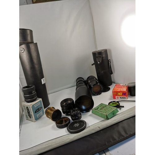 91 - Quantity of camera lenses and camera films inc, a Tamron 85-210mm lens, a Japanese long zoom lens al... 