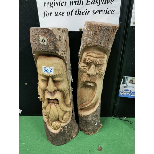 30c - Two carved log faces