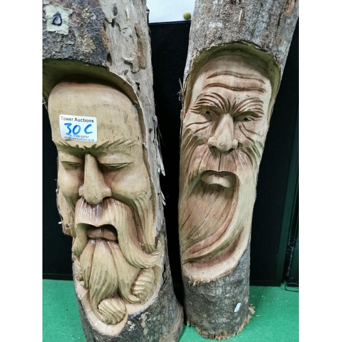 30c - Two carved log faces