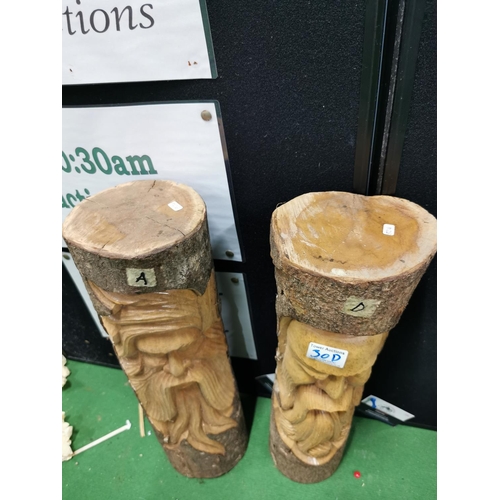 30d - Two carved log faces