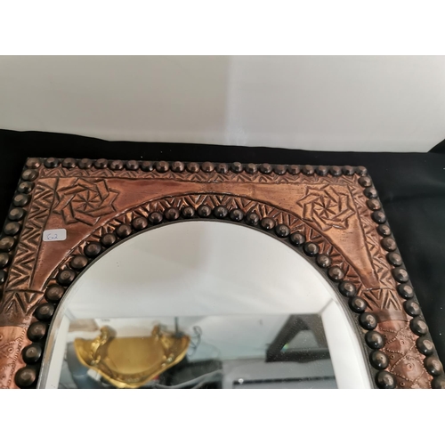 100 - Good hammered copper Arts and Crafts bevel edged mirror along with two brass wall vases, height of m... 