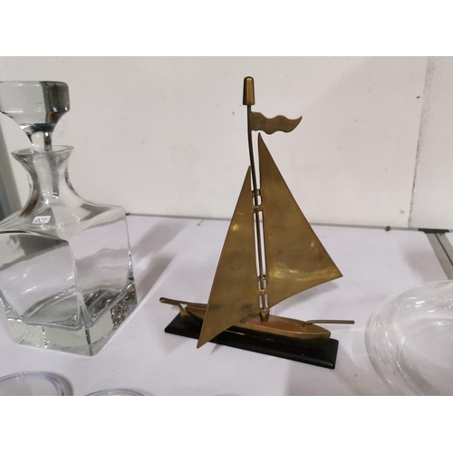 135 - Two glass decanters inc a ships decanter along with a brass sailing boat and 4 petri dishes.