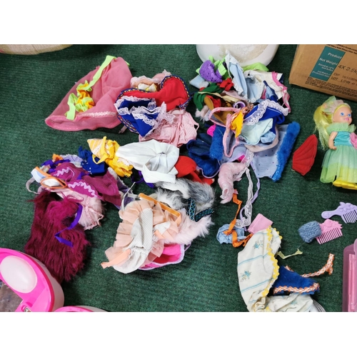 19 - Box full of dolls clothes along with a quantity of dolls