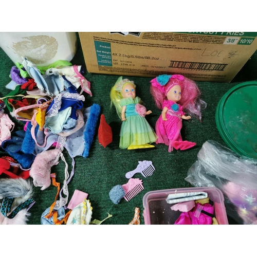 19 - Box full of dolls clothes along with a quantity of dolls