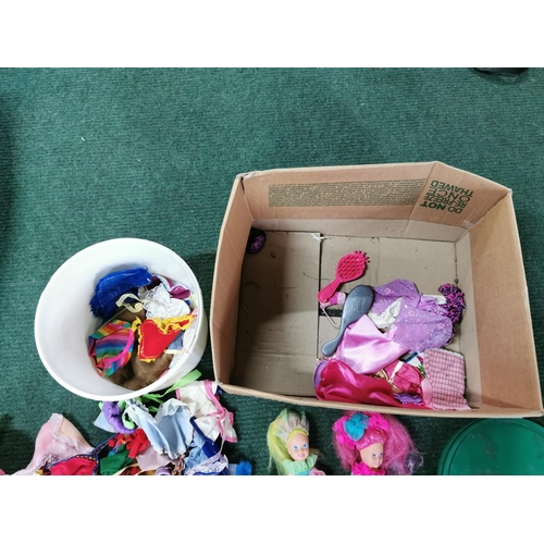 19 - Box full of dolls clothes along with a quantity of dolls