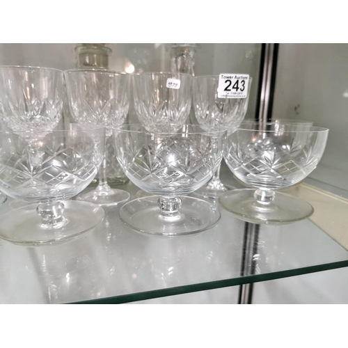 243 - Quantity of crystal glassware inc five grapefruit bowls and two decanters, one decanter has a chip.