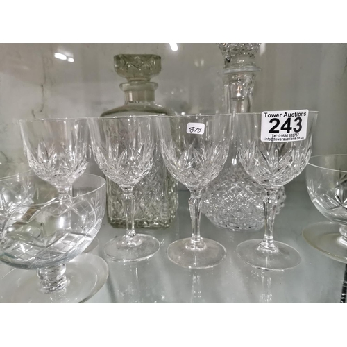 243 - Quantity of crystal glassware inc five grapefruit bowls and two decanters, one decanter has a chip.