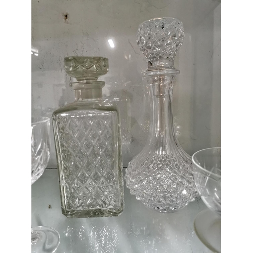 243 - Quantity of crystal glassware inc five grapefruit bowls and two decanters, one decanter has a chip.