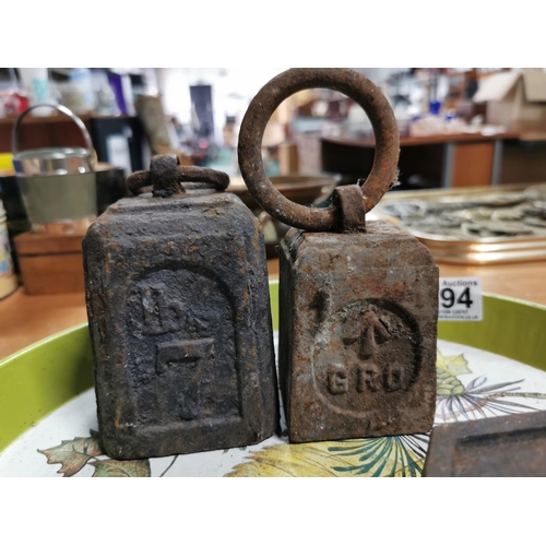 294 - Four vintage metal weights on a metal tray