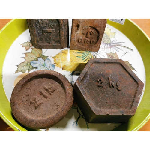 294 - Four vintage metal weights on a metal tray