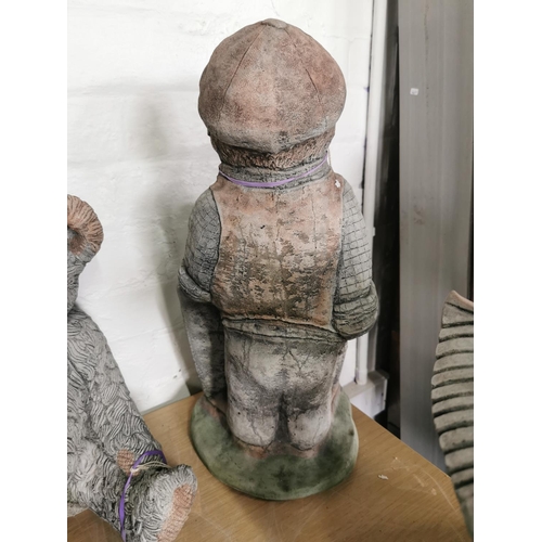 438 - Tall stone ware figure holding a sign never mind the dog beware of the owner 52cm high by 23cm wide