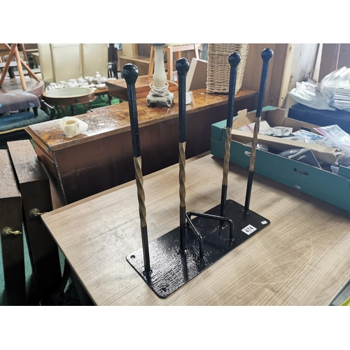 474 - Locally made wrought iron 2 pair boot stand with a boot jack  and a gilt twisted design