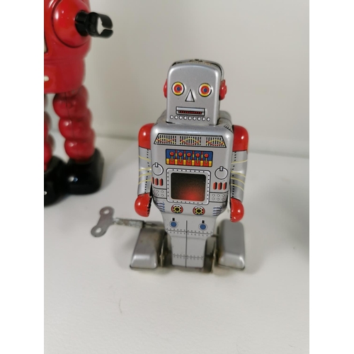 200e - Three vintage tin plate windup robots