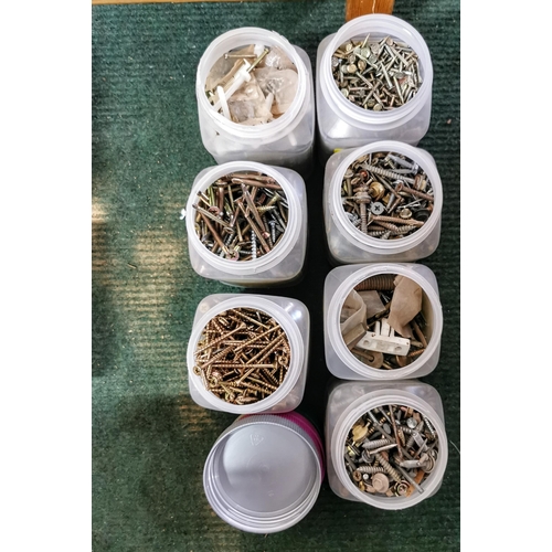 13 - Large quantity of screws in containers plus a car  battery charger drill bits etc