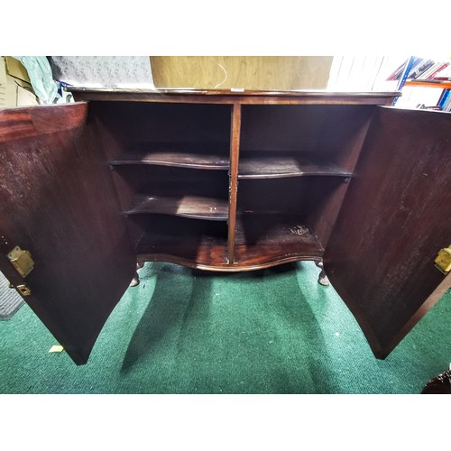 486 - Serpentine solid mahogany cabinet stamped W. Fowkes on top of the doors